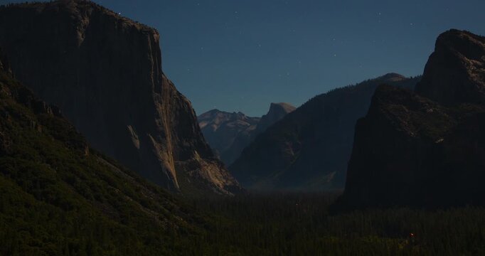 A tranquil night timelapse of Yosemite&rsquo;s Tunnel View under the moonlight. El Capitan and Half Dome rise over the valley as stars shimmer in the clear California sky.