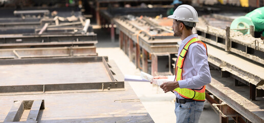 Engineer and foreman worker team checking project at precast factory site, Engineer and builders in hardhats discussing on construction site