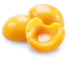 Peeled canned peach halves isolated on white background. File contains clipping paths.