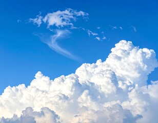Fluffy white clouds cluster against a bright, clear blue sky