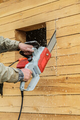 Man is using a chainsaw to cut wood
