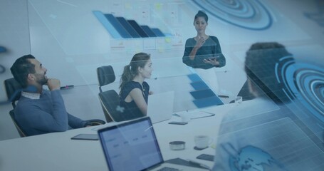 Presenting man gesturing at holographic data overlay on table with laptops in boardroom, copy space