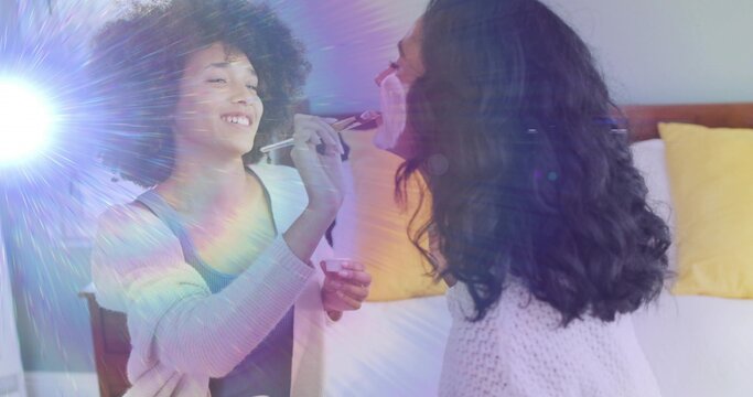 Applying makeup mother and daughter bonding in bedroom, with makeup brush, jar, lens flare
