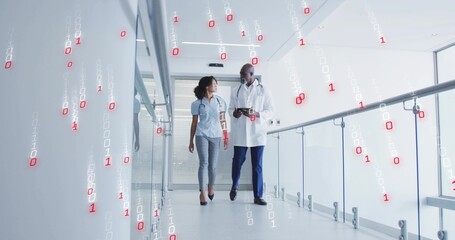Walking medical professionals viewing digital tablet in medical corridor, with binary code overlays