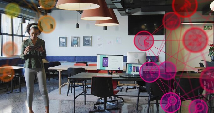 Mid adult woman tapping smartphone at coworking space desks, with digital overlay, copy space - Powered by Adobe