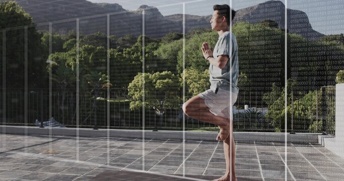 Balancing man holding tree pose wearing fitness tracker on terrace with grid overlay, copy space