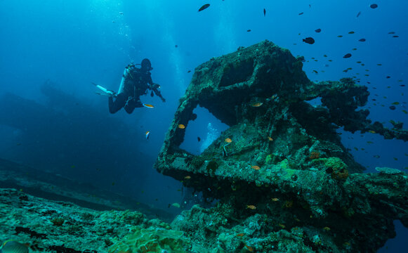 local dive master exploring wreck in the Maldives