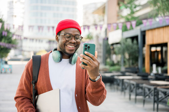 Smiling man making video call with smartphone outdoors on sunny autumn day