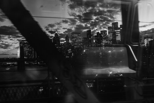 New York City skyline at night with bridge and water in black and white - Powered by Adobe