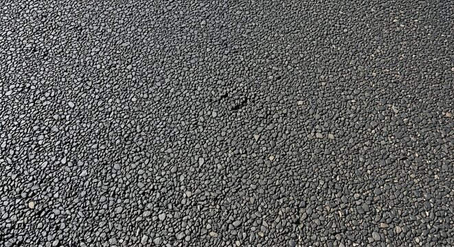 Close-up textured asphalt surface with small stones and gravel, perfect for construction, paving, and road surface backgrounds - Powered by Adobe