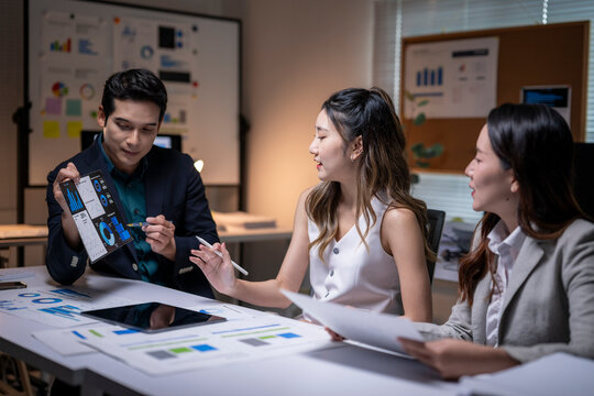 Business colleagues analyzing data on tablet during meeting