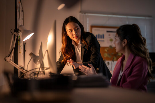 Businesswomen discussing during late night work in office
