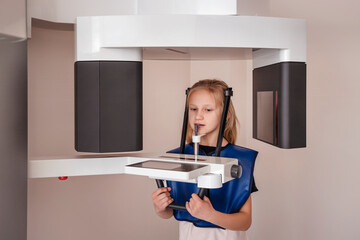 Orthopantomogram Digital image  for Children OPG CT Scan X-Ray. Child Little Girl Make Panoramic single Image Radiograph Mandible, Maxilla and Teeth. 