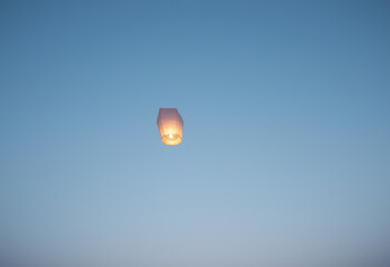 Sky Lantern Floating in Clear Blue Twilight Sky