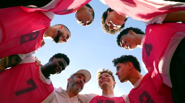 Motivated soccer team listening to coach during huddle