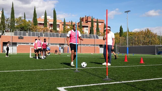 Soccer players practicing dribbling skills during a training session