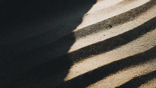 Captivating Abstract Pattern of Sunlight and Shadows Forming Dramatic Stripes on Textured Surface.