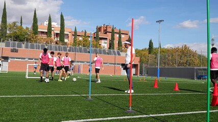 Young soccer players dribbling during training practice session - Powered by Adobe