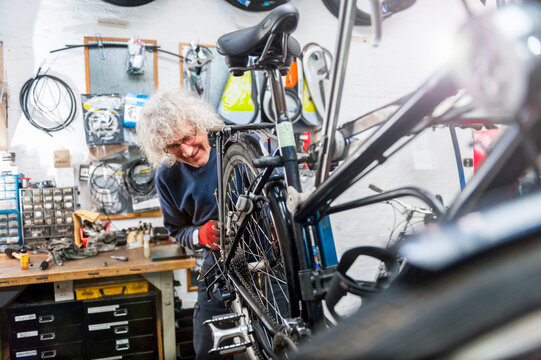 Bicycle mechanic working in bike shop