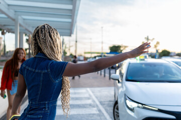 Young woman hailing a taxi on city street