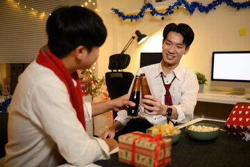 Festive office mood with snacks, wrapped gifts, and colleagues toasting with cold drinks