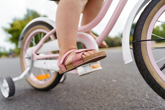 Girl riding bicycle on road