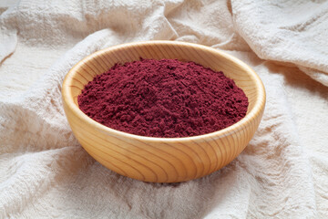 Red yeast rice powder in wooden bowl, Chinese traditional food and medicine