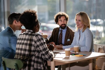 Diverse business team collaborating during an informal coffee meeting