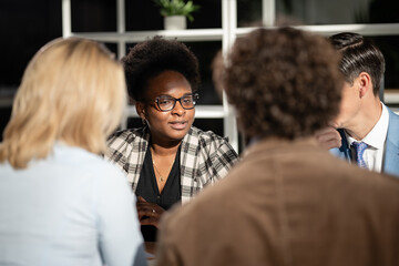 Diverse business professionals discussing during office meeting