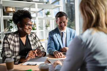 Diverse business team collaborating and smiling during office meeting