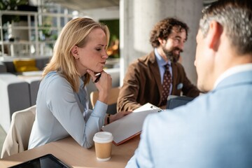 Obraz premium Businesswoman thinking during corporate meeting with colleagues