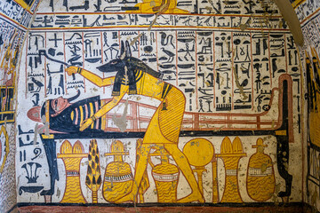 Obraz premium Ancient Egyptian Tomb Painting of Anubis Tending to the Mummy
