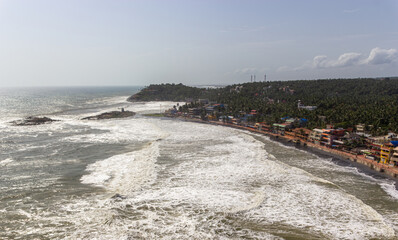 Massive Foaming Ocean Waves Crashing onto the Coastal Village