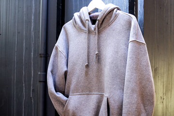 Comfortable Gray Hoodie Hanging Casually on Display