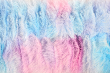 A full frame, overhead shot of a colorful, fluffy, pastel pink and blue faux fur texture