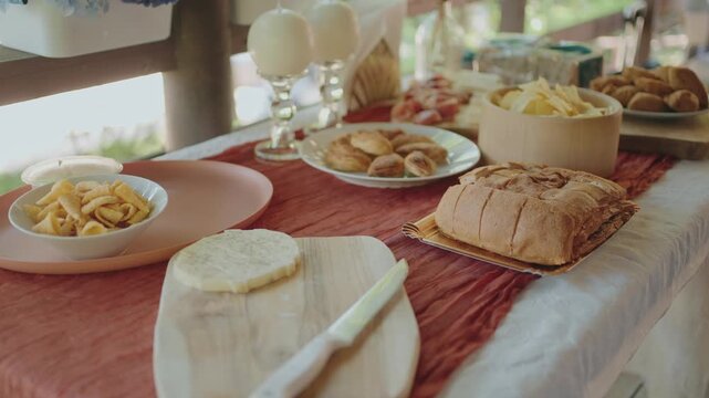 cozy outdoor dining setup with bread cheese and assorted appetizers