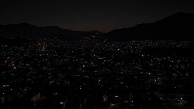 Aerial night footage of Kathmandu city during Diwali (Tihar), featuring the illuminated Dharahara Tower and glowing skyline filled with festive lights, showing Nepal&rsquo;s vibrant cultural celebration.
