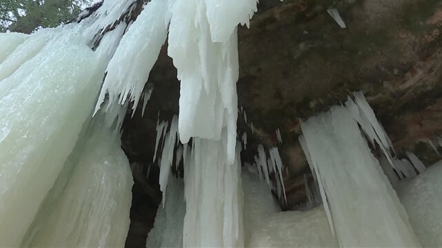 Water Dripping On The Ceiling Of Eben Ice Caves With Stalactites In Michigan, USA. - low angle shot