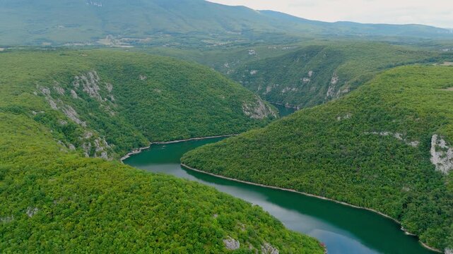 Aerial drone view of the Vrbas River in Bosnia and Herzegovina, wide angle scenic panoramic view of green valley