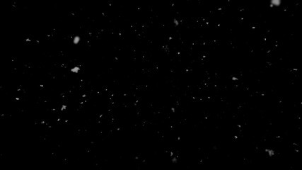 Realistic heavy snow flurry with varied particle sizes falls against isolated black background. For winter storm or blizzard scenes