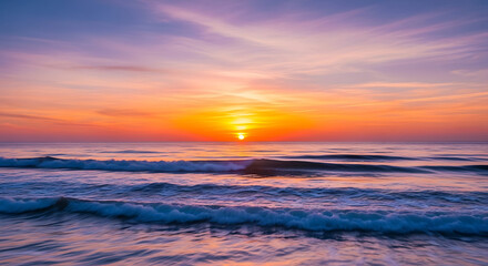 Ocean waves under a vibrant sunset with colorful sky backdrop
