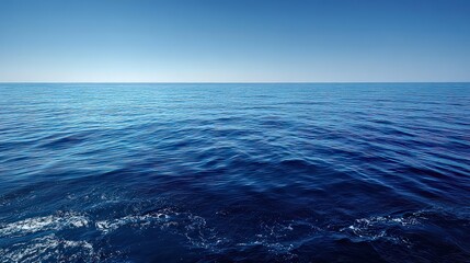 Obraz premium Seascape Vista of Deep Blue Ocean Water Sparkling Under the Sunlight Reflecting a Clear Sky in Horizontal Composition and Calm Serene Water