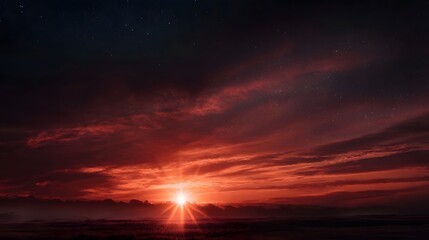 Obraz premium A dramatic celestial scene featuring a brilliant sunburst with light rays illuminating crimson clouds and stars above a dark misty horizon