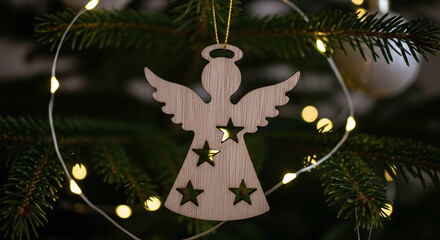 Rustic wooden angel ornament with star cutouts hangs on a decorated christmas tree with fairy lights