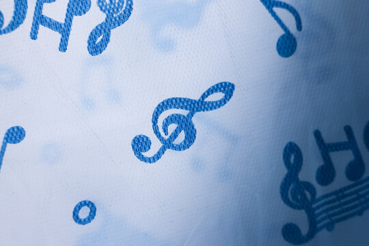 Gentle blue music note background with treble clef focus. An abstract art concept of sound, melody, and rhythm. creative, classic paper design for musical score or theme