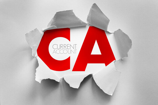 CA abbreviation bursts through torn paper, symbolizing financial access and banking functionality. Current Account concept conveyed with bold letters and clean professional presentation