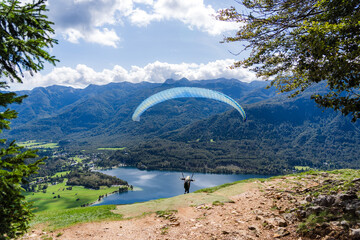 Paraglider Launching from Takeoff Site over Lake Bohinj in the Julian Alps, Slovenia on a Sunny Day