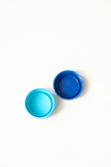 Blue water plastic caps for recycling isolated on white background