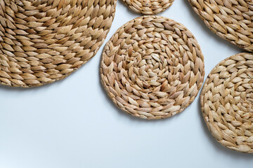 A round woven placemat made from natural water hyacinth isolated on white background