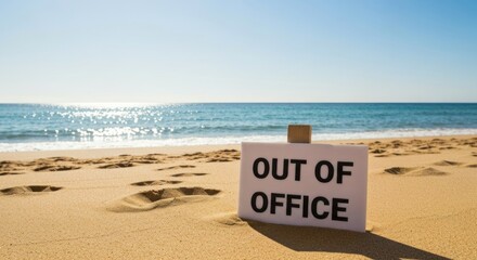 Beach scene with "OUT OF OFFICE" sign in sand, ocean in background